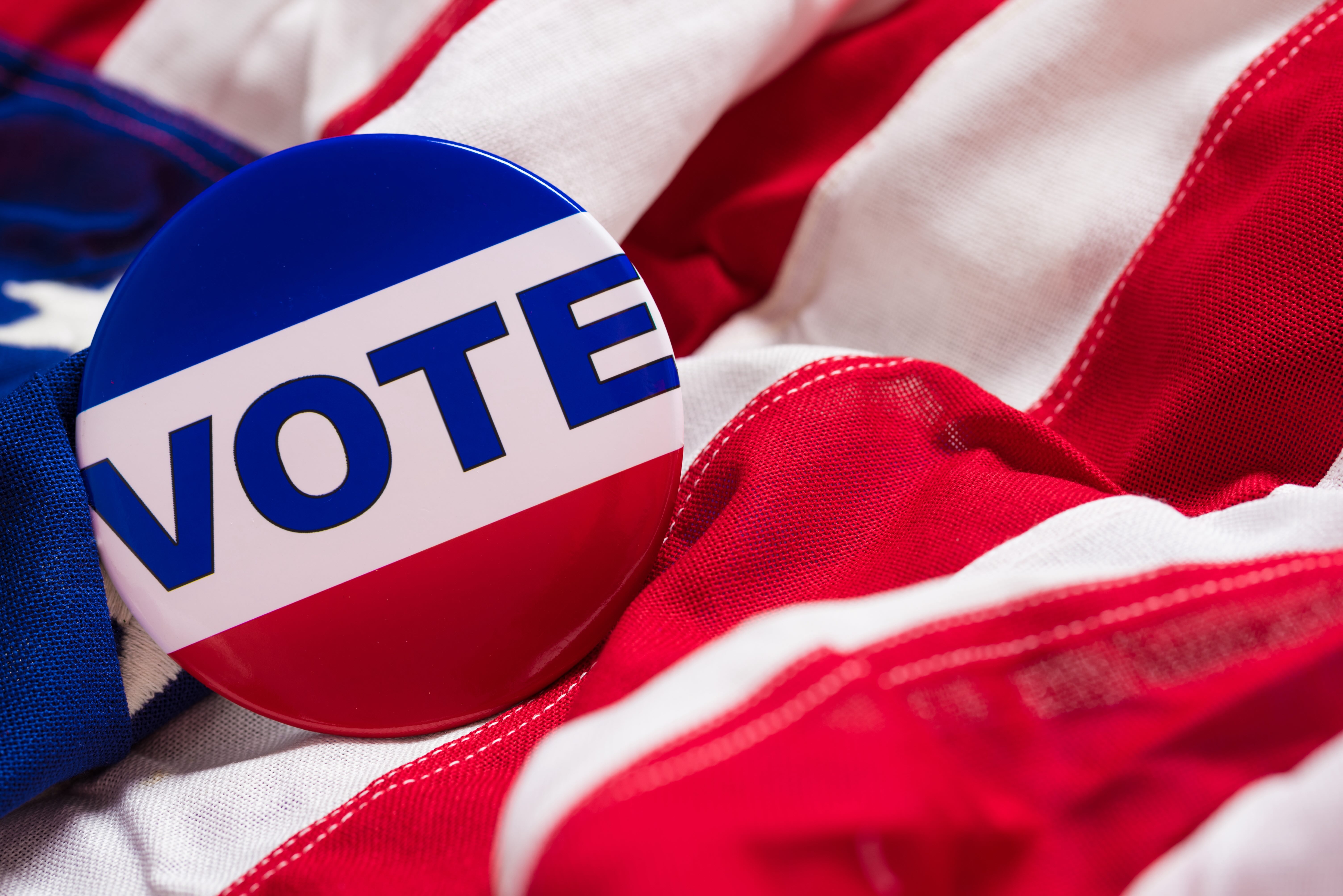 Vote pin on top of American flag