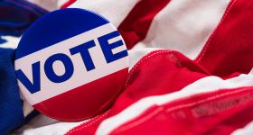 Vote pin on top of American flag